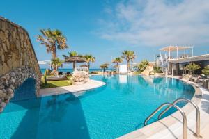 a swimming pool at a resort with the ocean in the background at Mirage Arillas Studio Type C17 in Arillas +17 photos