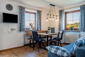 a living room with a table and chairs at Mongaduierhof Apt Latemar in Umes