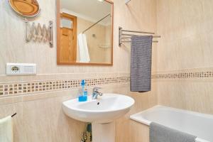 a bathroom with a sink and a mirror and a tub at Apartamento B y G Nerja in Nerja +23 photos