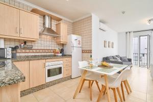 a kitchen and dining room with a table and chairs at Apartamento B y G Nerja in Nerja