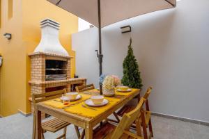 a dining room with a table and a fireplace at V L P Amorim in Ponta Delgada