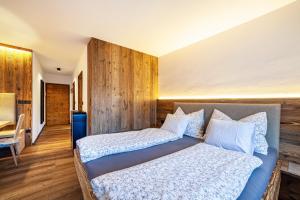 a bedroom with two beds with white sheets and a table at Ferienwohnung Kuppelwies 363 in Ultimo +10 photos