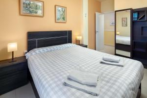 a bedroom with a bed with two towels on it at Villa Pepa in Chilches +27 photos