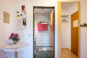 a small bathroom with a table and a shower at Haus Leufke in Lenzkirch +67 photos
