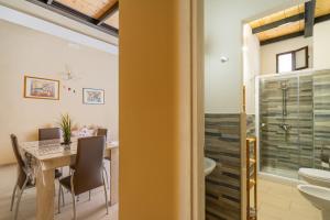 ein Esszimmer mit Tisch und ein Badezimmer in der Unterkunft La rimesa di Tittì - Simone in Alezio + 15 Fotos