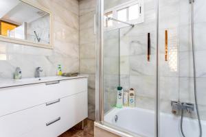 a bathroom with a shower and a tub and a sink at San Antonio in Sedaví +16 photos