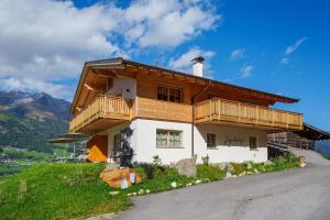 a house on top of a hill with a balcony at Gögelehof in San Martino