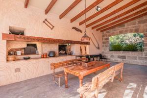 a kitchen and dining room with a wooden table at Es Rafal in Santa Margalida