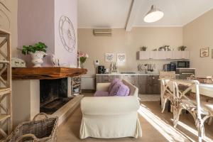 a living room with a fireplace and a table and chairs at Villa Maria Beatrice in Quartu SantʼElena