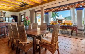 a kitchen and dining room with a table and chairs at Can Andreuet in Sant Carles de Peralta