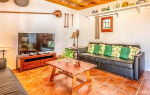 a living room with a couch and a tv at Can Andreuet in Sant Carles de Peralta
