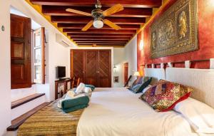 a bedroom with a large bed with a ceiling fan at Can Andreuet in Sant Carles de Peralta +16 photos