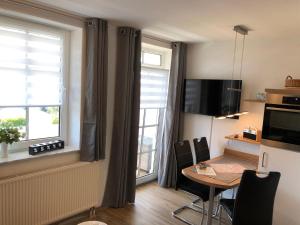 a small room with a table and a window at Villa Bella Vista - Meerblick 1 in Sassnitz