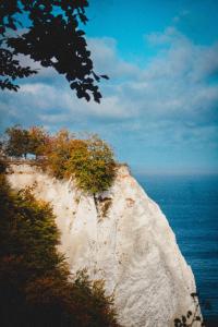 a large white cliff next to the ocean at Villa Bella Vista - Meerblick 1 in Sassnitz +10 photos