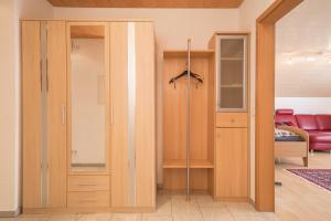 a closet with a glass door in a room at Ferienwohnung Welte in Meckenbeuren