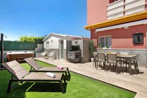 a backyard with a patio with a table and chairs at Villa Hyc Playa de las burras in Maspalomas