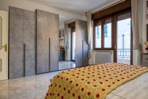a bedroom with a bed with red flowers on it at Casa Ester in Francavilla Fontana