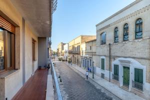 an empty street in a city with buildings at Casa Ester in Francavilla Fontana