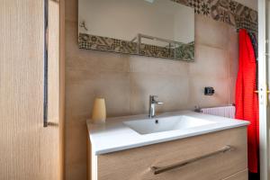 a bathroom with a white sink and a mirror at Casa Ester in Francavilla Fontana +22 photos