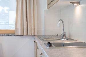a kitchen with a sink and a window at Hilber Sass Rigais in Villnoss +17 photos