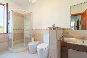 a bathroom with a shower and a toilet and a sink at Le colline sul mare in Sortino +19 photos