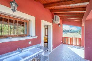 a kitchen with a sink and a large window at Le colline sul mare in Sortino