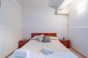 a bedroom with a bed and two night stands at Le colline sul mare in Sortino