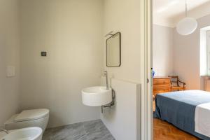 a bathroom with a sink and a toilet and a bed at Villa Brecht in Bagni di Lucca +37 photos