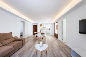 a living room with a couch and a table at Albercutx Pollentia 2 in Port de Pollensa