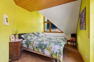 a bedroom with a bed and a window at Almschlössle in Gottmadingen
