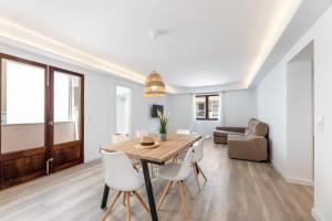 a dining room and living room with a table and chairs at Albercutx Pollentia 2 in Port de Pollensa