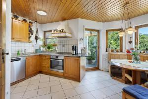 a kitchen with wooden cabinets and a wooden ceiling at Almschlössle in Gottmadingen