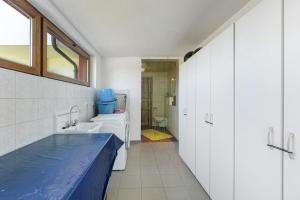 a bathroom with white cabinets and a blue counter top at Almschlössle in Gottmadingen +26 photos