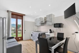 a kitchen with a table and chairs and a kitchen with a dining room at Casa Sandrina in Caprino Veronese