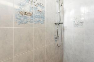 a bathroom with a shower with a painting on the wall at Villa Sauvageonne in Saint-Raphaël +13 photos