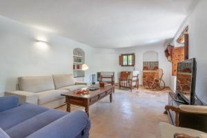 a living room with a couch and a table at Villa S'erisal in Alaró