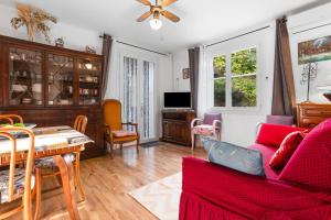 a living room with a couch and a table at Villa Sauvageonne in Saint-Raphaël