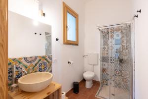 a bathroom with a shower and a sink and a toilet at Casa delle Pigne in Camporeale