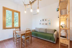 a living room with a couch and a table at Casa delle Pigne in Camporeale
