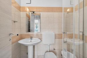 a bathroom with a sink and a toilet and a mirror at Casa Sandrina in Caprino Veronese +13 photos