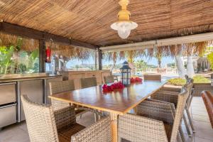 an outdoor dining area with a wooden table and chairs at Villa Quesada in Paguera