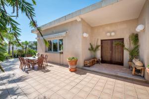 a patio of a house with a table and chairs at Villa Quesada in Paguera