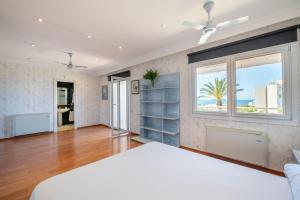 a bedroom with a white bed and a window at Villa Quesada in Paguera +21 photos