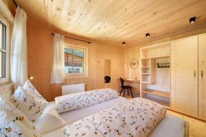 a bedroom with a bed in a room with wooden walls at Gögelehof in San Martino