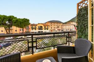 a balcony with chairs and a view of a city at Casa Sandrina in Caprino Veronese