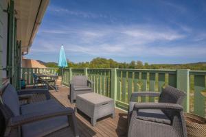 a deck with chairs and a table and an umbrella at T3 au calme avec terrasse in Cogolin