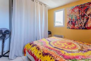 a bedroom with a bed and a painting on the wall at T3 au calme avec terrasse in Cogolin
