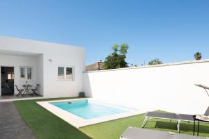 a white house with a swimming pool in a yard at Casa Lavanda Vejer in La Muela