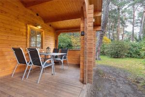 a wooden deck with a table and chairs on it at Ferienhaus Waldblick in Berlin