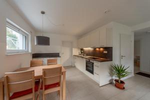 a kitchen with a table and a dining room at Ferienwohnung Gluiber in Beuren